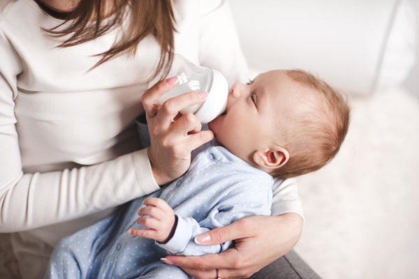 woman feeding her baby with bottle